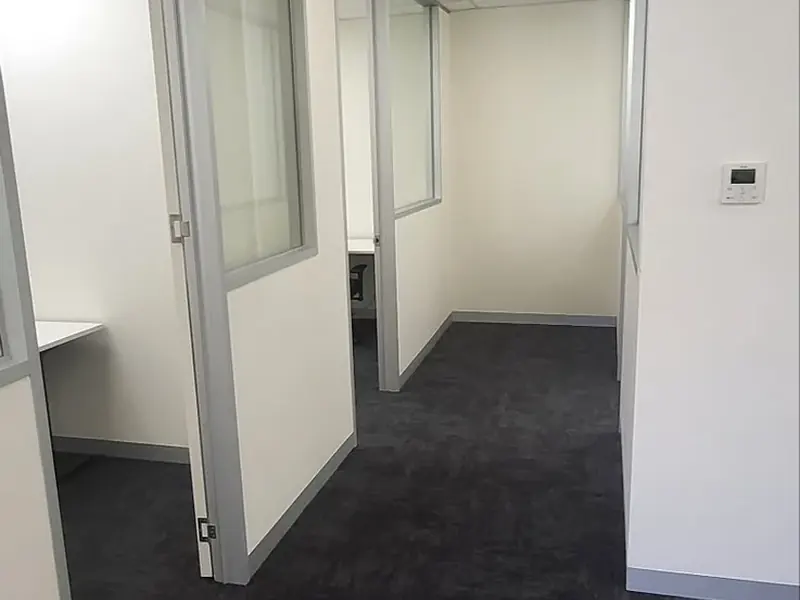 Completed glazed office entrances in a commercial corridor