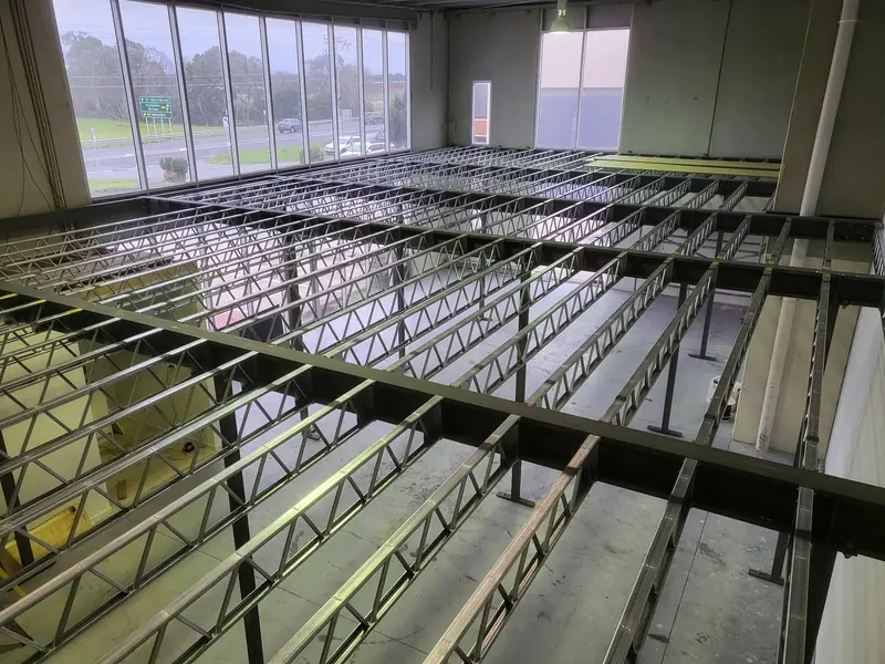 Timber floor framing installed over a steel mezzanine structure