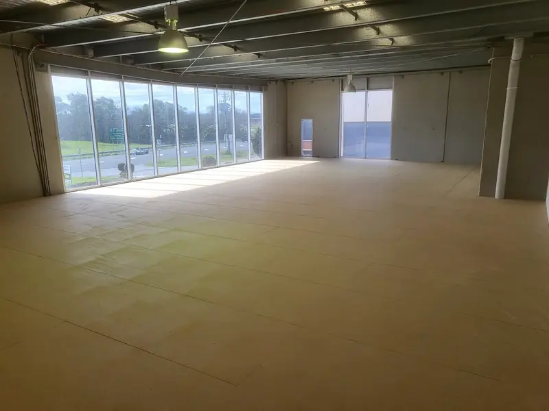 Completed upper-level commercial workspace with finished walls, ceiling and floor