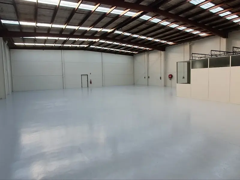 Resurfaced warehouse floor with a clean light-grey finish